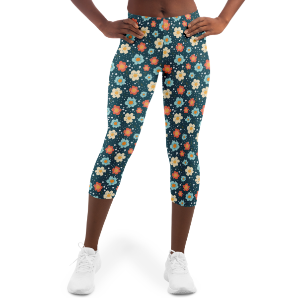 Blue Flower Power Capri Leggings on a model yellow blue orange flowers on a dark blue background