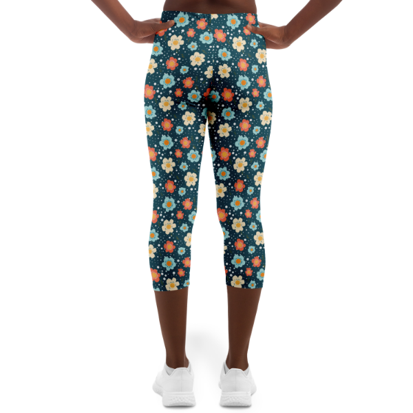 Blue Flower Power Capri Leggings on a model yellow blue orange flowers on a dark blue background
