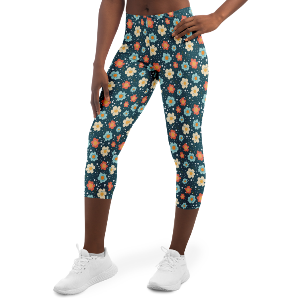 Blue Flower Power Capri Leggings on a model yellow blue orange flowers on a dark blue background