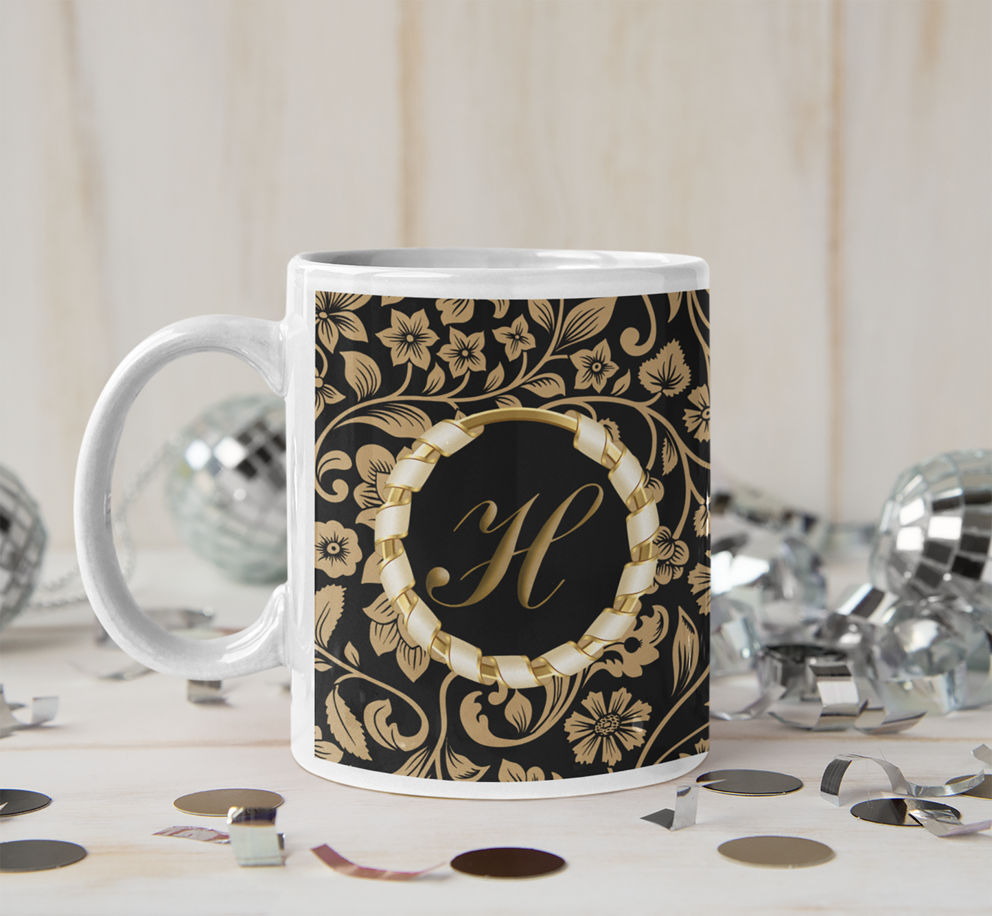 decorative black and gold initialled mug on a party background