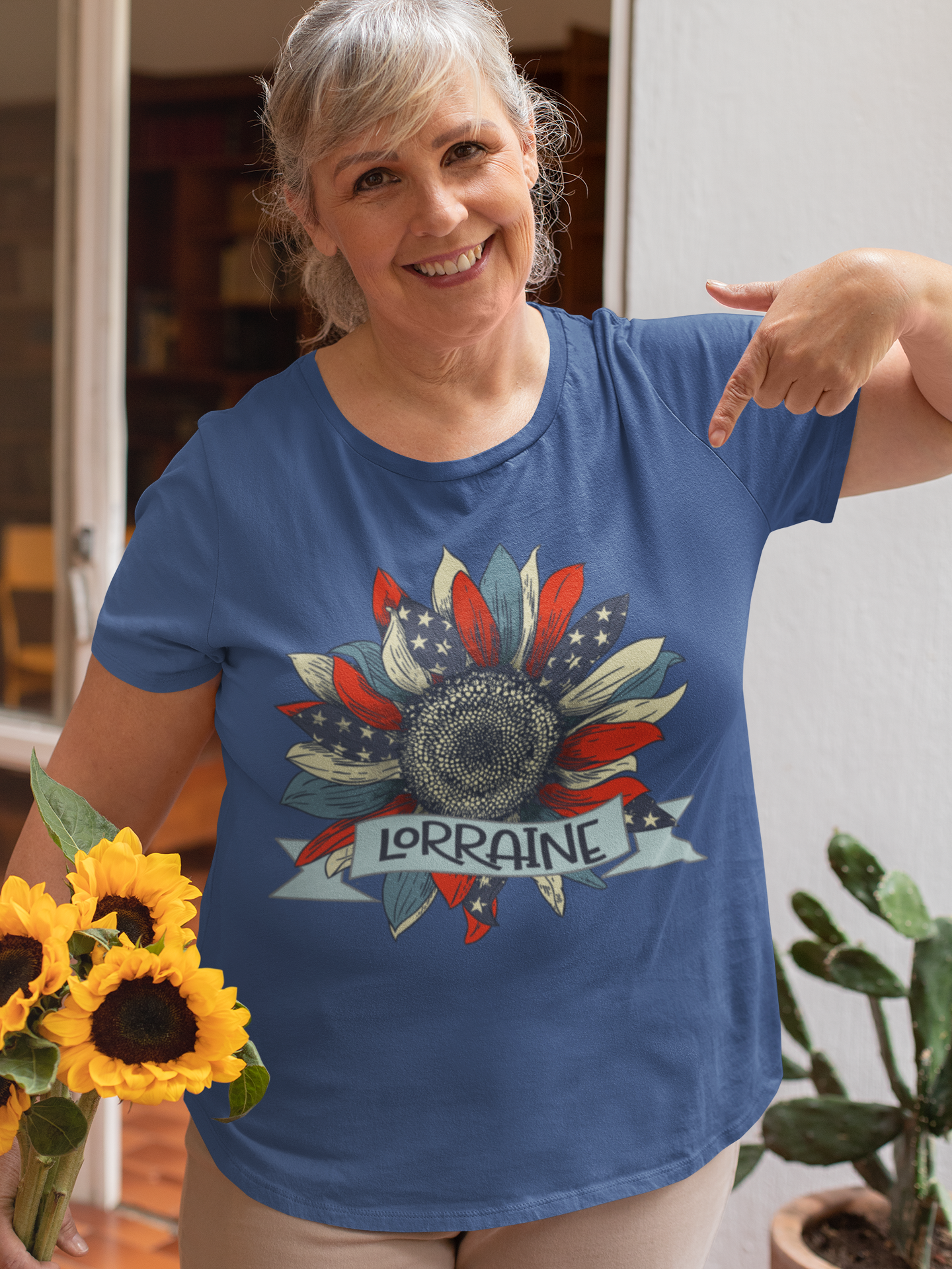 woman pointing at blue tshirt with usa flag sunflower motif