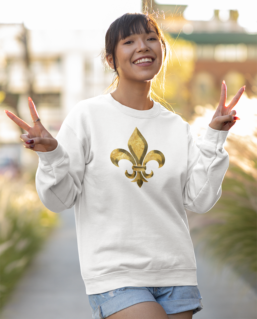 pretty woman showing peace signs smiling  she wears a white long sleeve sweatshirt
