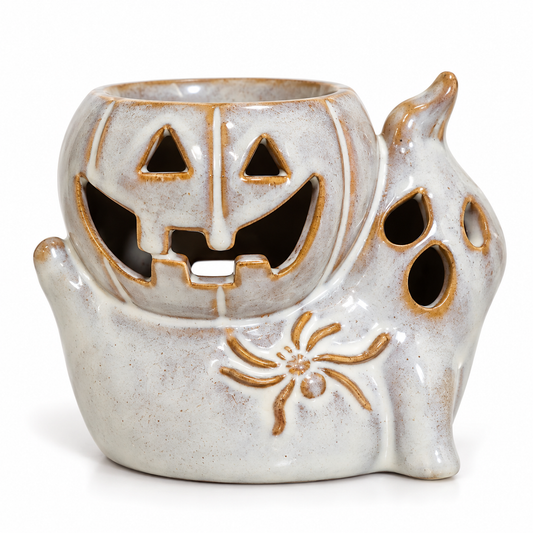 Small ceramic pumpkin and ghost wax melter with a pale glazed finish, smiling jack-o’-lantern face and raised spider detail, displayed against a clean, light background.