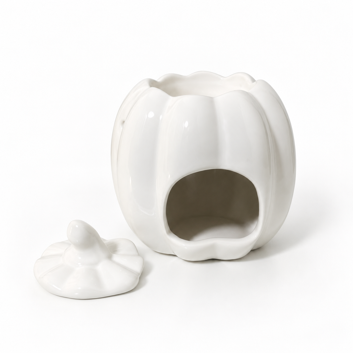 A white ceramic pumpkin-shaped container with a matching lid, shown on a clean white background.