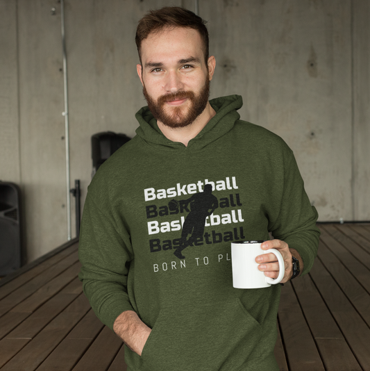 Bearded man smiling to camera holding a mug and wearing a green basketball hoodie